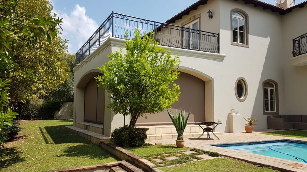 Sheerweave roller blinds providing UV protection on a covered patio